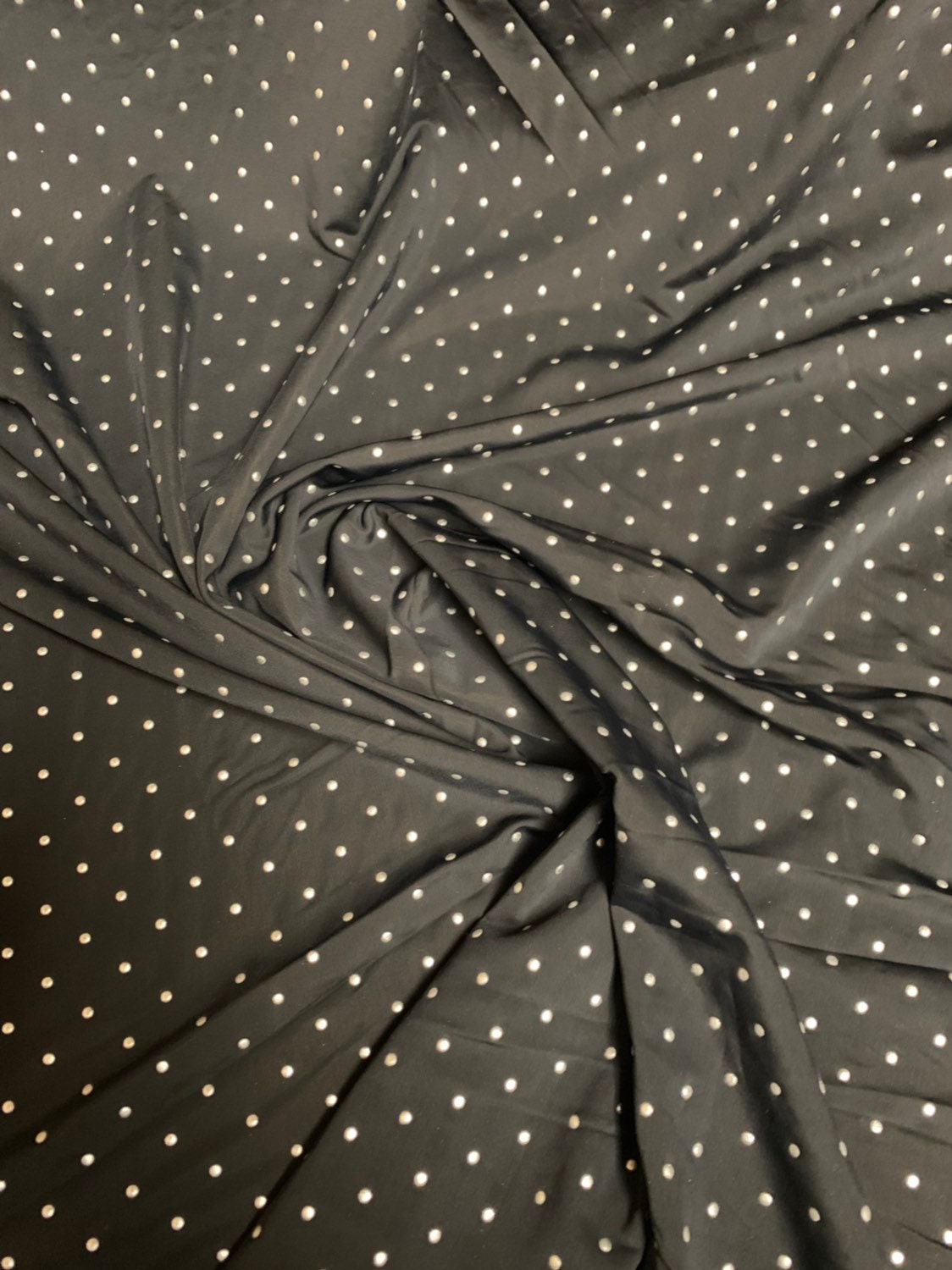 Metallic dots on heavy nylon spandex 4way stretch 58/60" Sold by the YD. Ships worldwide from Los Angeles California USA.
