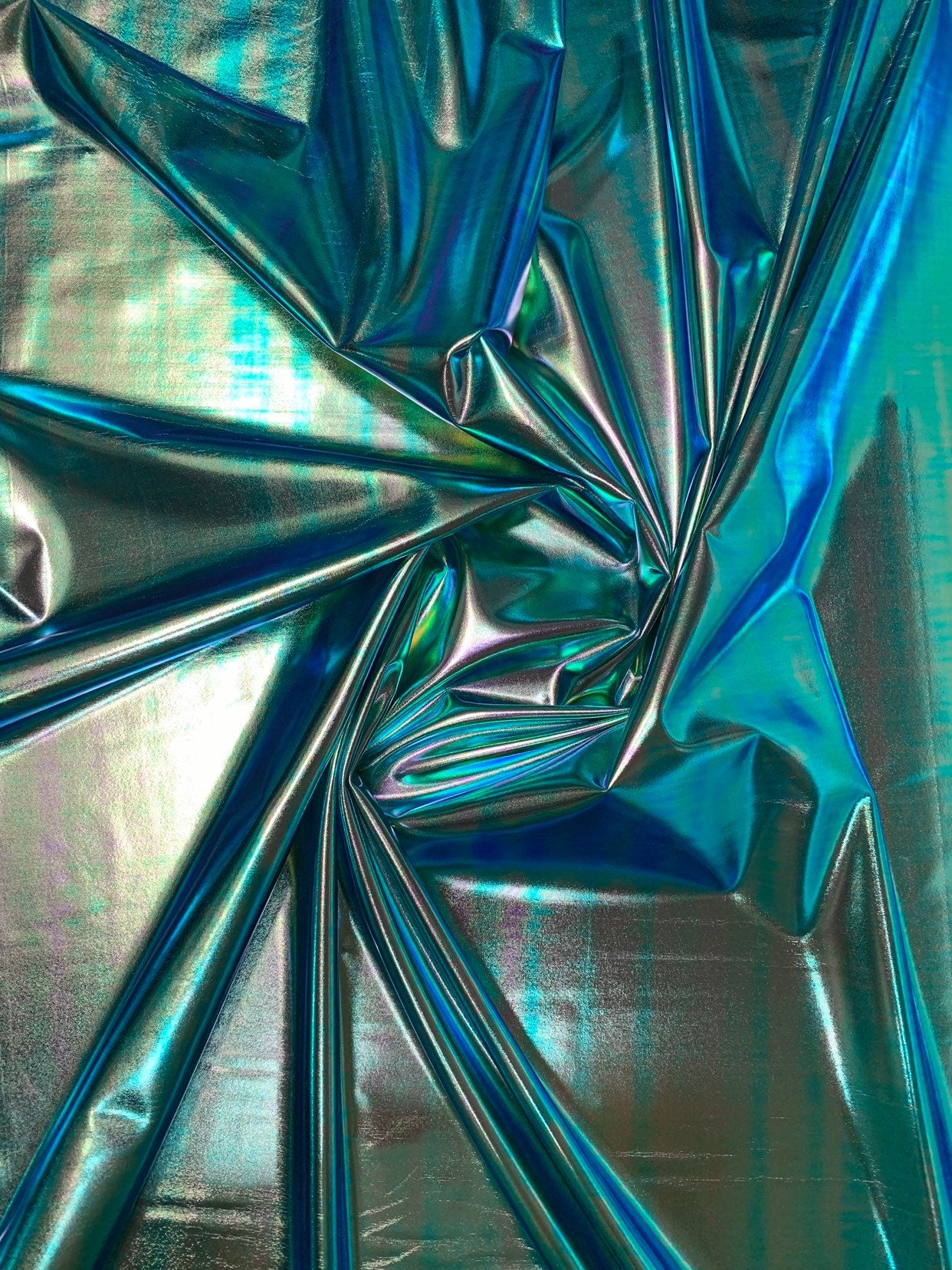New blue green iridescent foil metallic spandex foil 4way stretch 58/60" Sold by the YD. Ships worldwide from Los Angeles California USA.