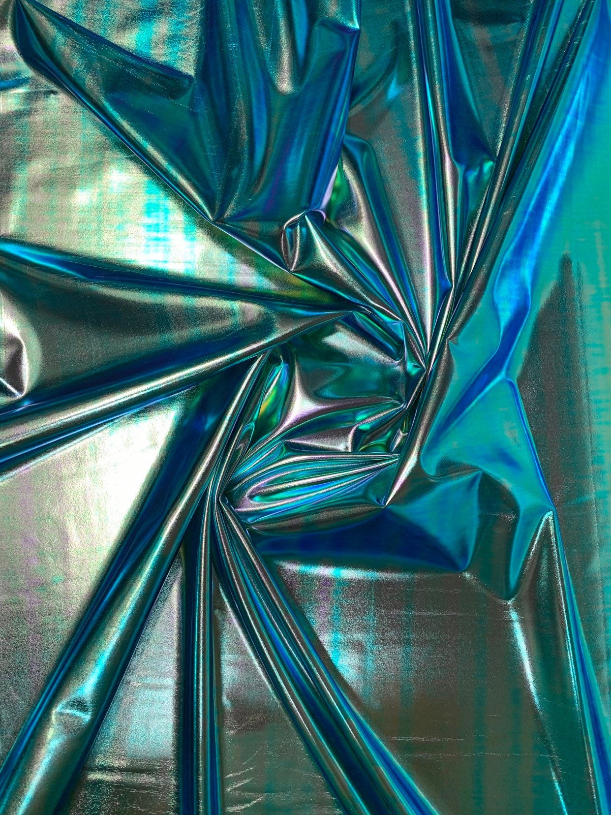 New blue green iridescent foil metallic spandex foil 4way stretch 58/60" Sold by the YD. Ships worldwide from Los Angeles California USA.