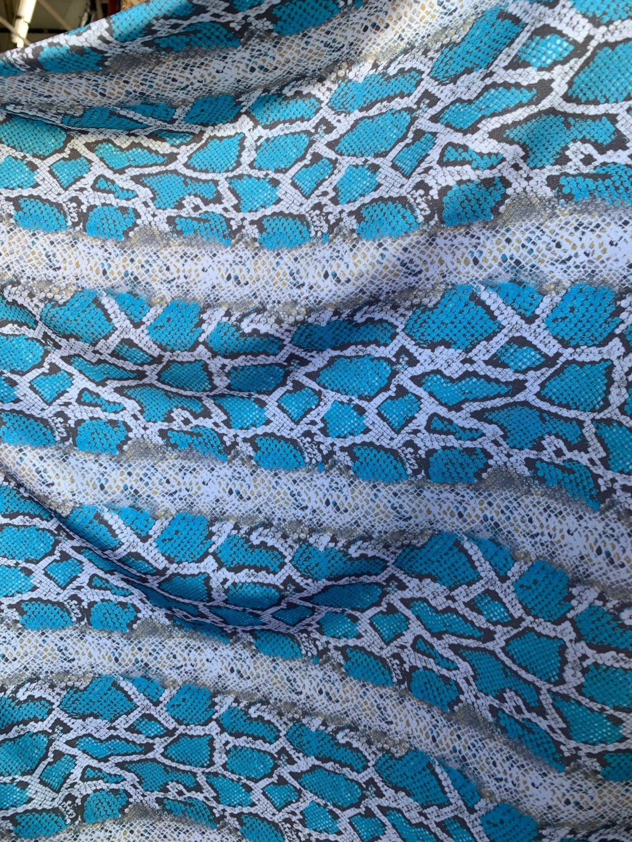 New snake print white/blue/gray  print on nylon spandex 4way stretch 58/60" Sold by the YD. Ships worldwide from Los Angeles California USA.