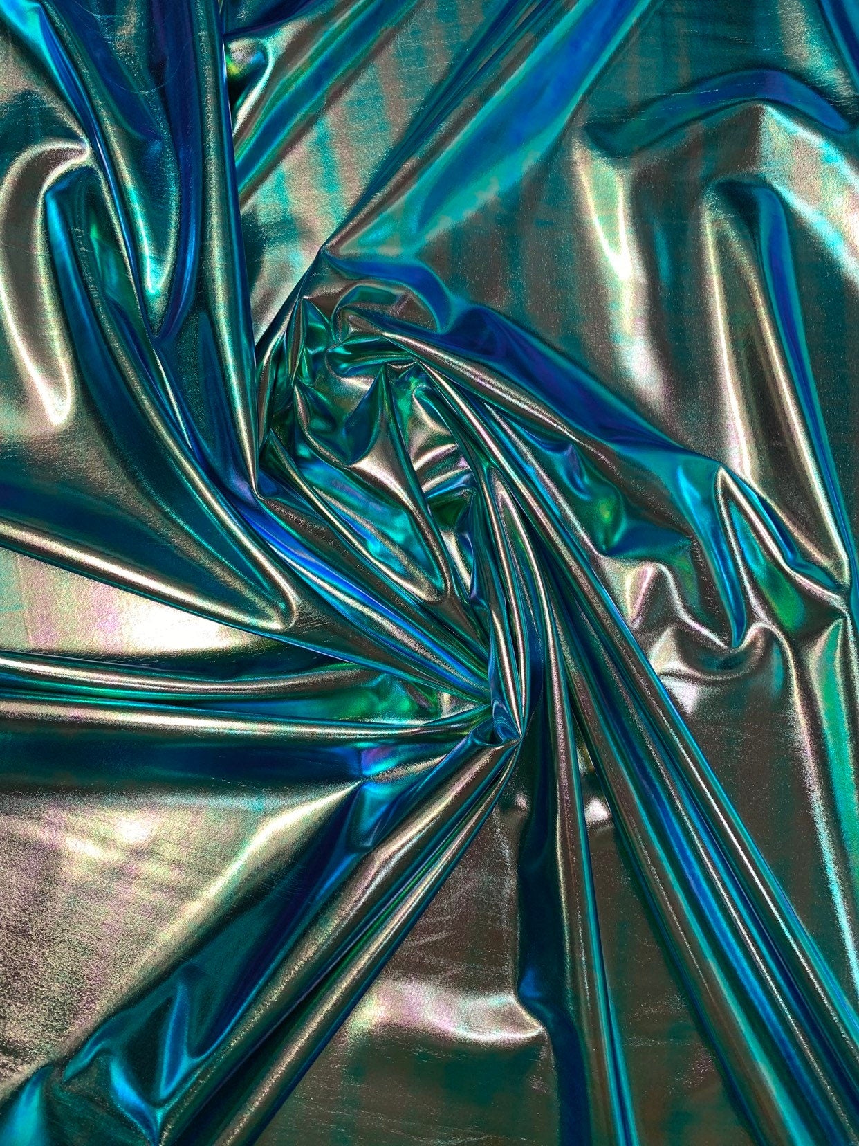 New blue green iridescent foil metallic spandex foil 4way stretch 58/60" Sold by the YD. Ships worldwide from Los Angeles California USA.