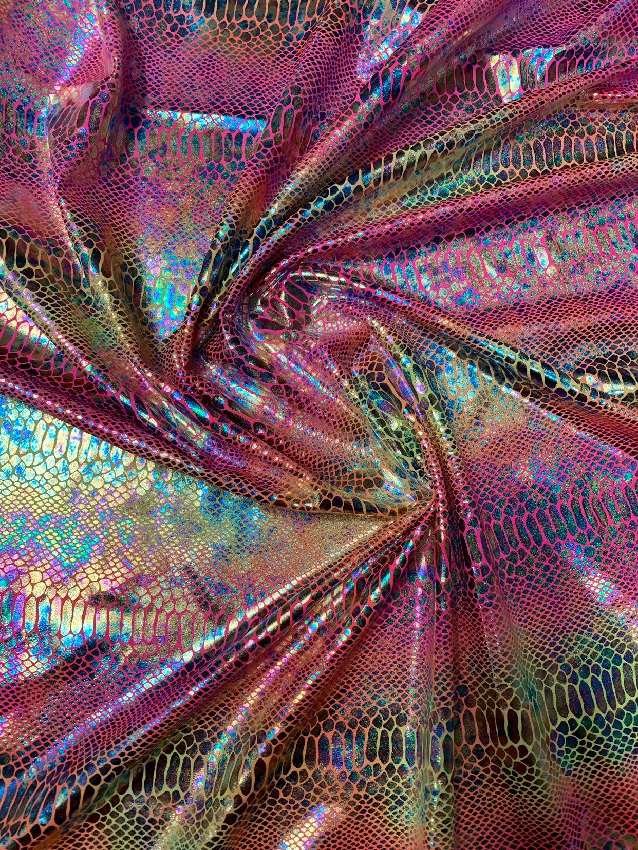 New Iridescent hologram snake design with clear multicolor foil 4way stretch 58/60" Sold by the YD. Ships worldwide from Los Angeles CA USA.