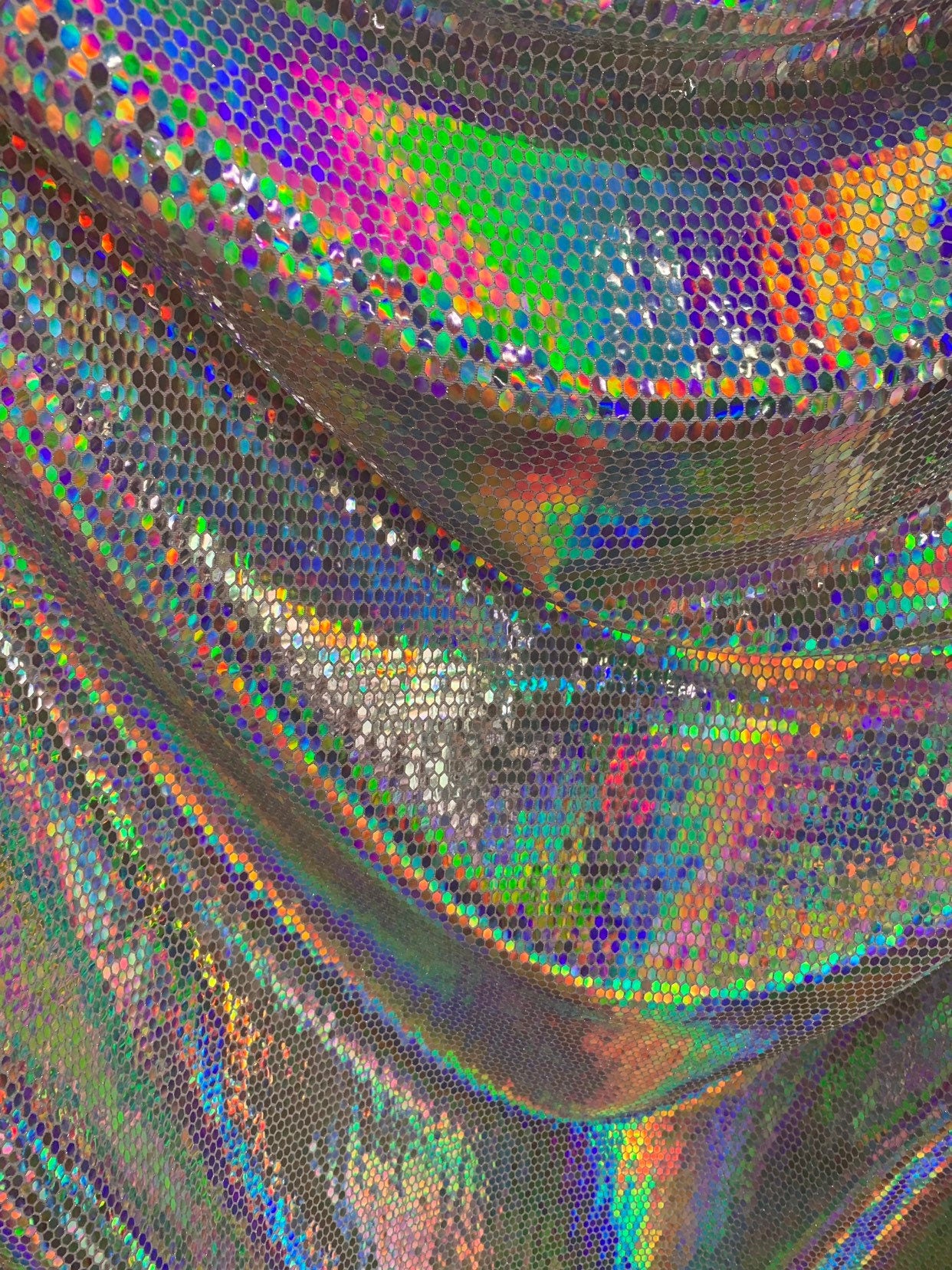 New hexagon geometric iridescent sequins on metallic spandex base 4way stretch 58/60" Sold by the YD. Ships worldwide from Los Angeles CA.