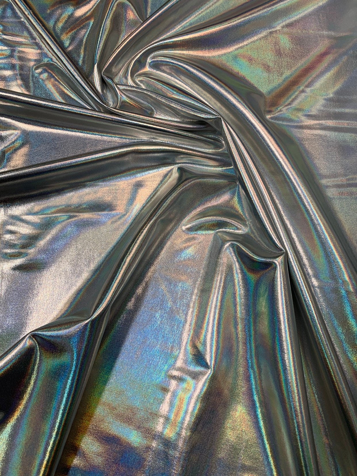 Iridescent silver all over foil metallic nylon Spandex 4way stretch 58/60" Sold by the YD. Ships worldwide from Los Angeles California USA