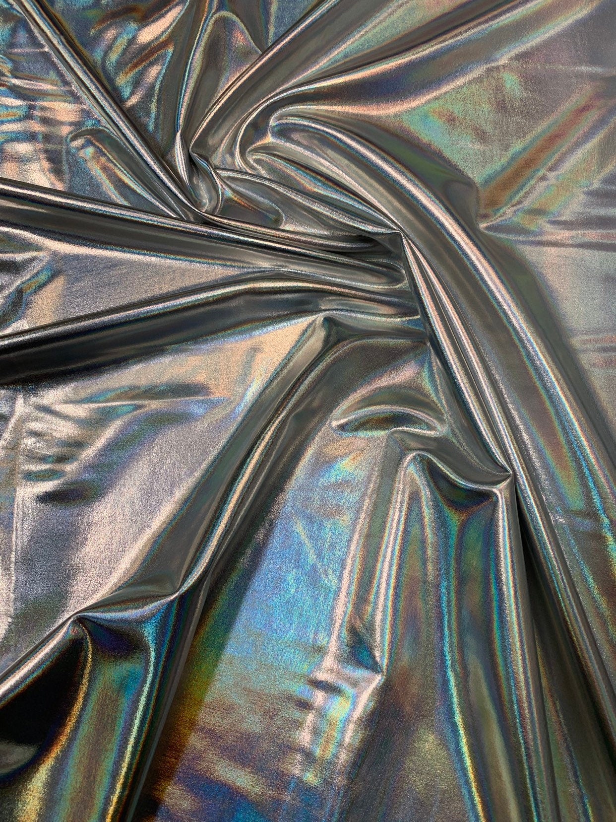 Iridescent silver all over foil metallic nylon Spandex 4way stretch 58/60" Sold by the YD. Ships worldwide from Los Angeles California USA