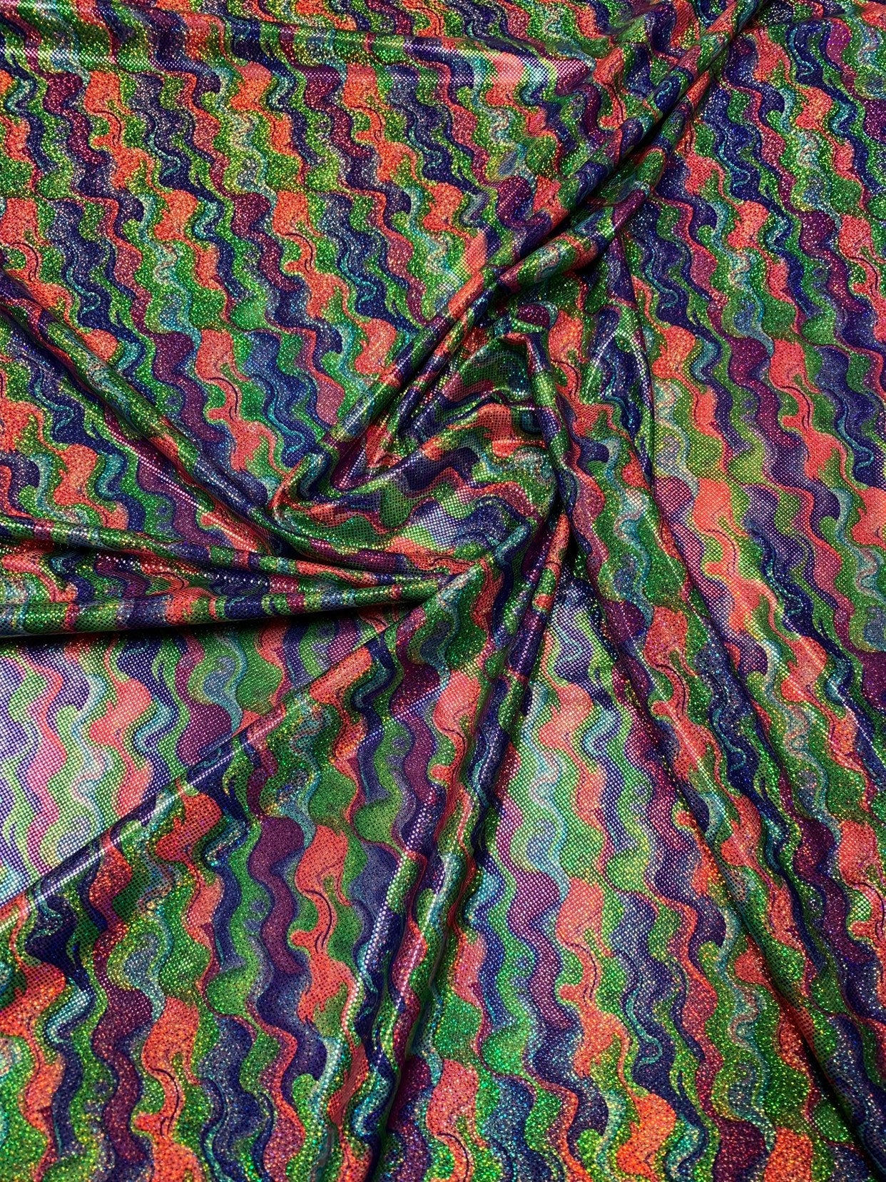 Lava design hologram metallic nylon spandex purple/lavender/green 4way stretch 58/60" Sold by the YD. Ships worldwide from Los Angeles CA.