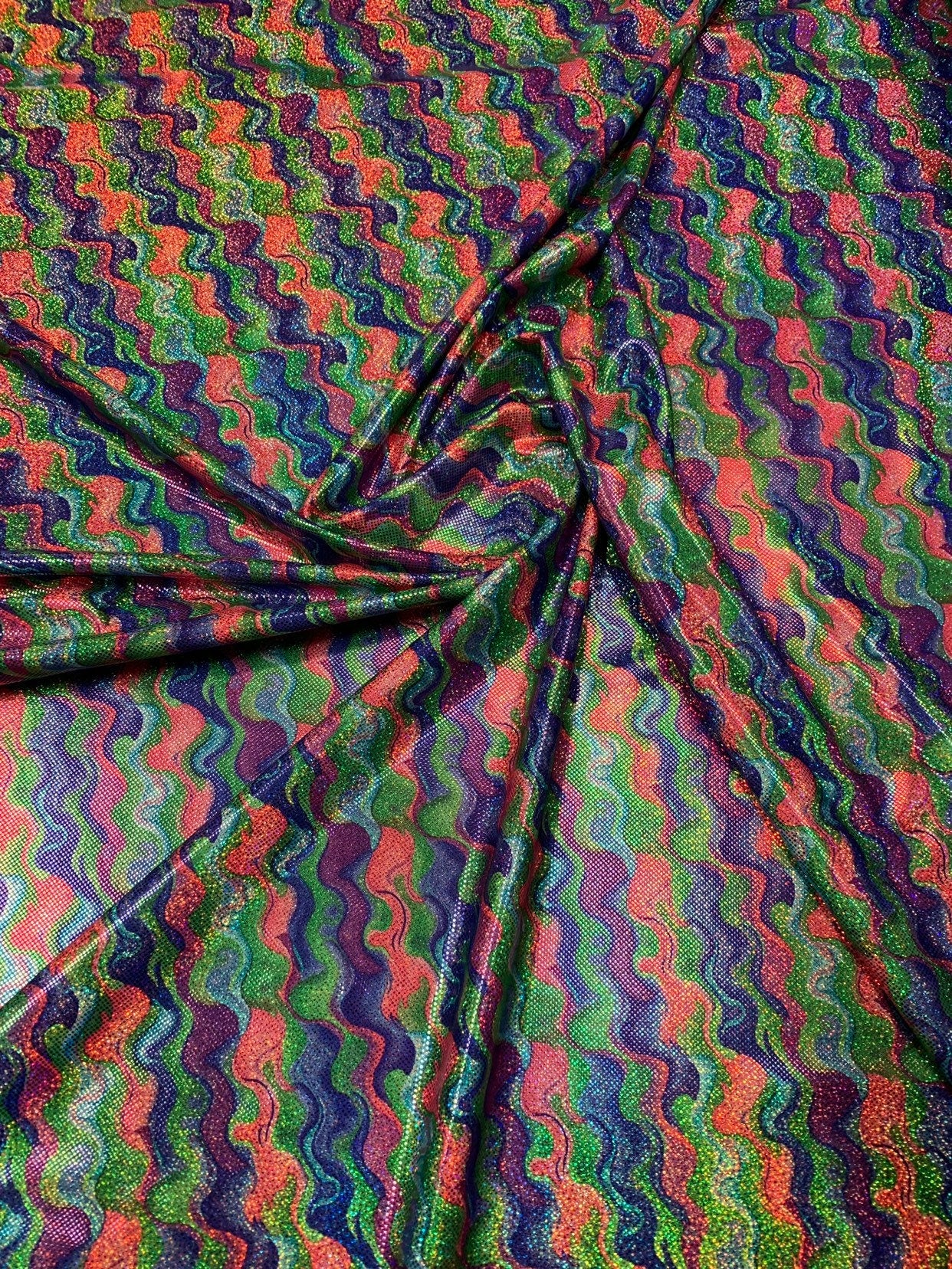 Lava design hologram metallic nylon spandex purple/lavender/green 4way stretch 58/60" Sold by the YD. Ships worldwide from Los Angeles CA.