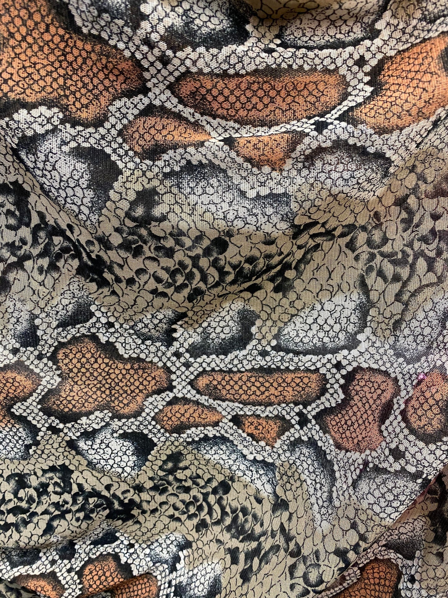 New exotic snake design taupe/black print on stretch mesh 4-way 58/60” Sold by the YD. Ships worldwide from Los Angeles California USA.