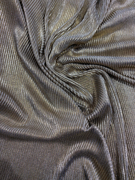 New metallic poly pleated black/gold medium weight fabric 2-way stretch 58/60” Sold by the YD. Ships worldwide from Los Angeles CA USA.
