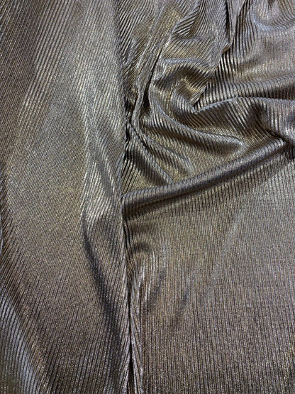 New metallic poly pleated black/gold medium weight fabric 2-way stretch 58/60” Sold by the YD. Ships worldwide from Los Angeles CA USA.