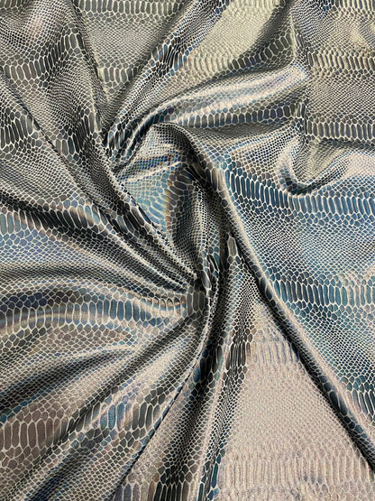 New Iridescent snake design silver/gray metallic hologram nylon spandex 4-way stretch 58/60” Sold by the YD. Ships worldwide from L.A CA.