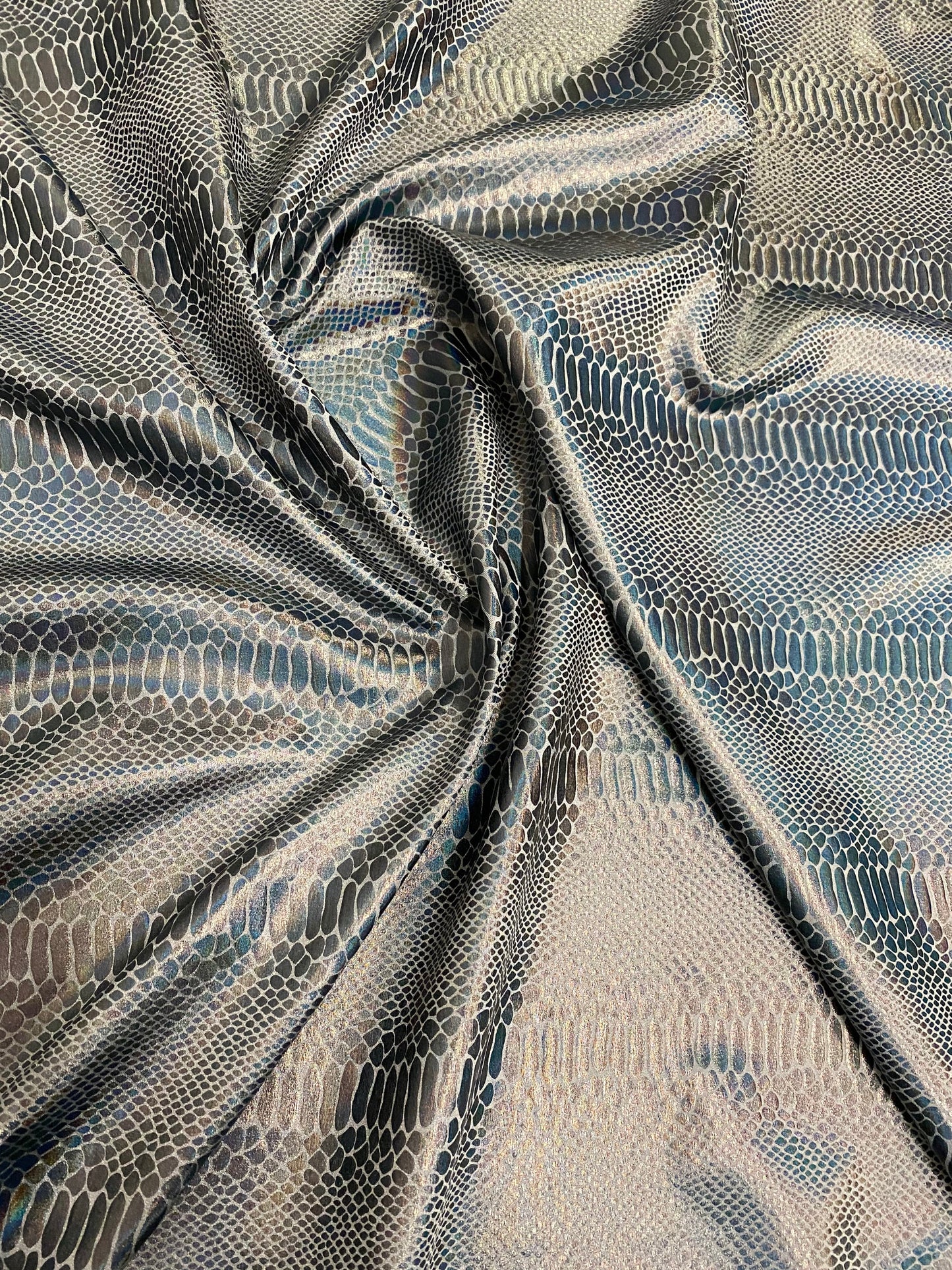 New Iridescent snake design silver/gray metallic hologram nylon spandex 4-way stretch 58/60” Sold by the YD. Ships worldwide from L.A CA.