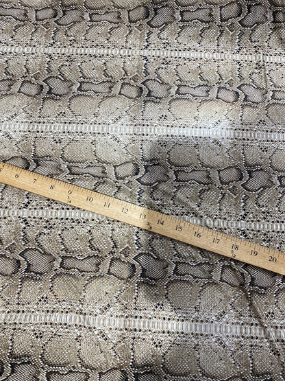 New exotic snake design taupe/black medium weight 4-way stretch 58/60” Sold by the YD. Ships worldwide from Los Angeles California USA.