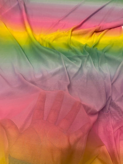 New rainbow design power mesh 4-way stretch nylon quality 58/60” Sold by the YD. Ships worldwide from Los Angeles California USA.