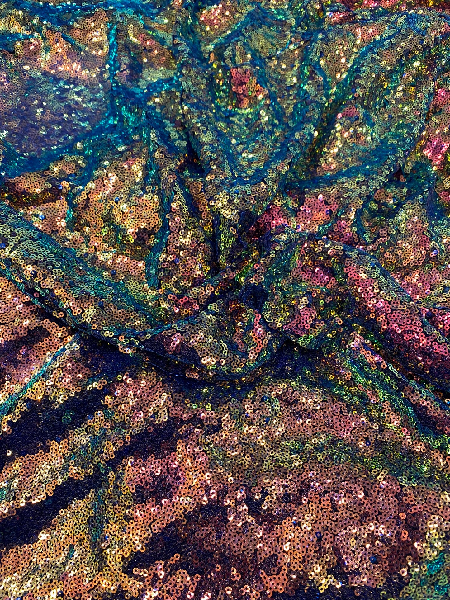 New cosmic iridescent sequins sapphire bronze color on stretch mesh 2-way stretch 58/60” Sold by the YD. Ships worldwide from Los Angeles CA