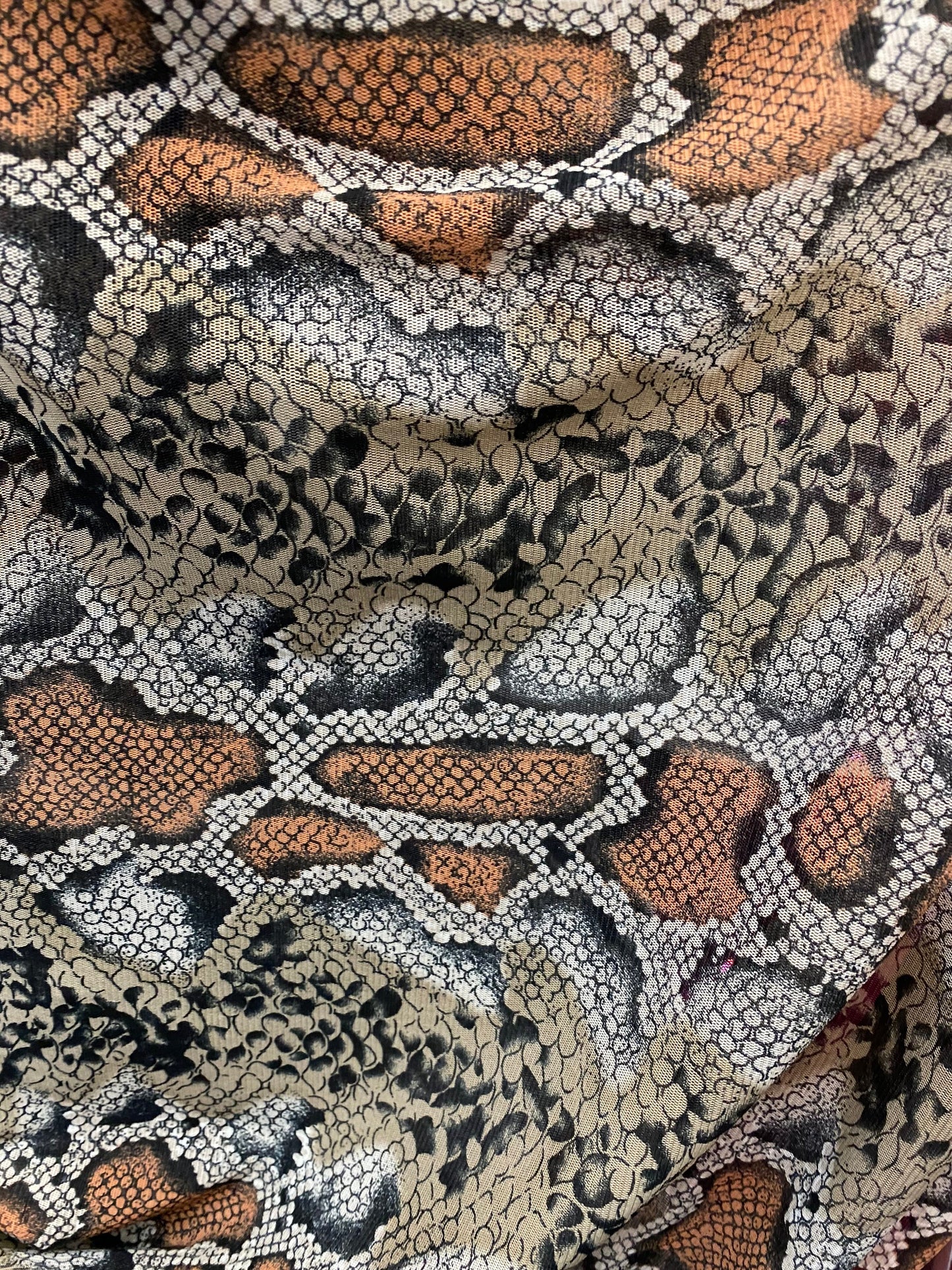New exotic snake design taupe/black print on stretch mesh 4-way 58/60” Sold by the YD. Ships worldwide from Los Angeles California USA.