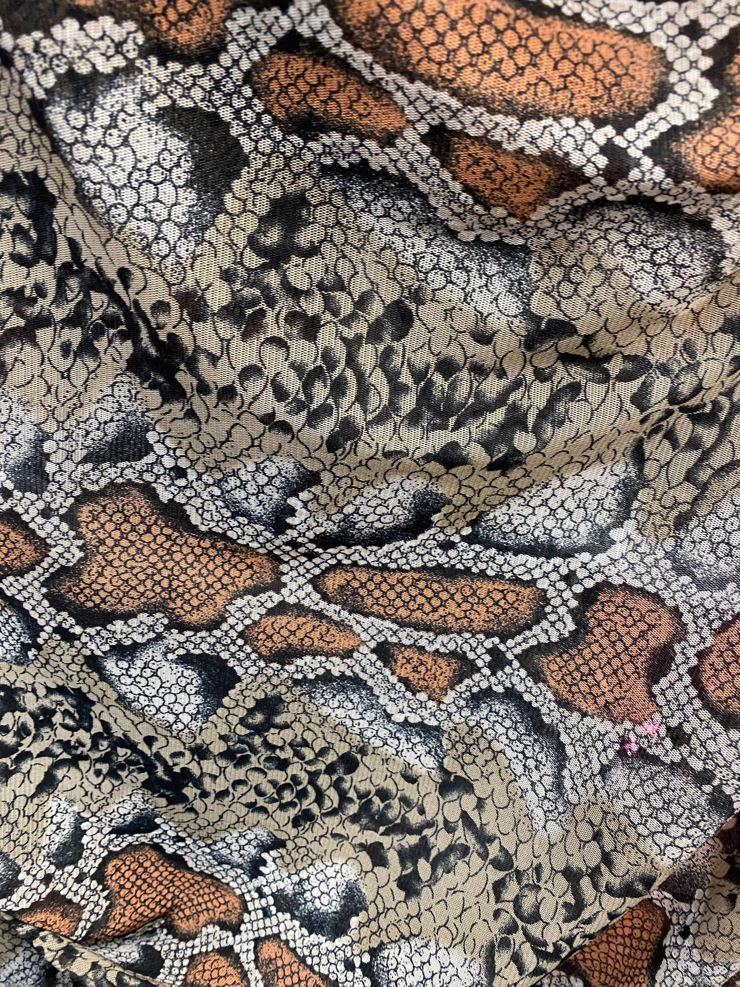 New exotic snake design taupe/black print on stretch mesh 4-way 58/60” Sold by the YD. Ships worldwide from Los Angeles California USA.