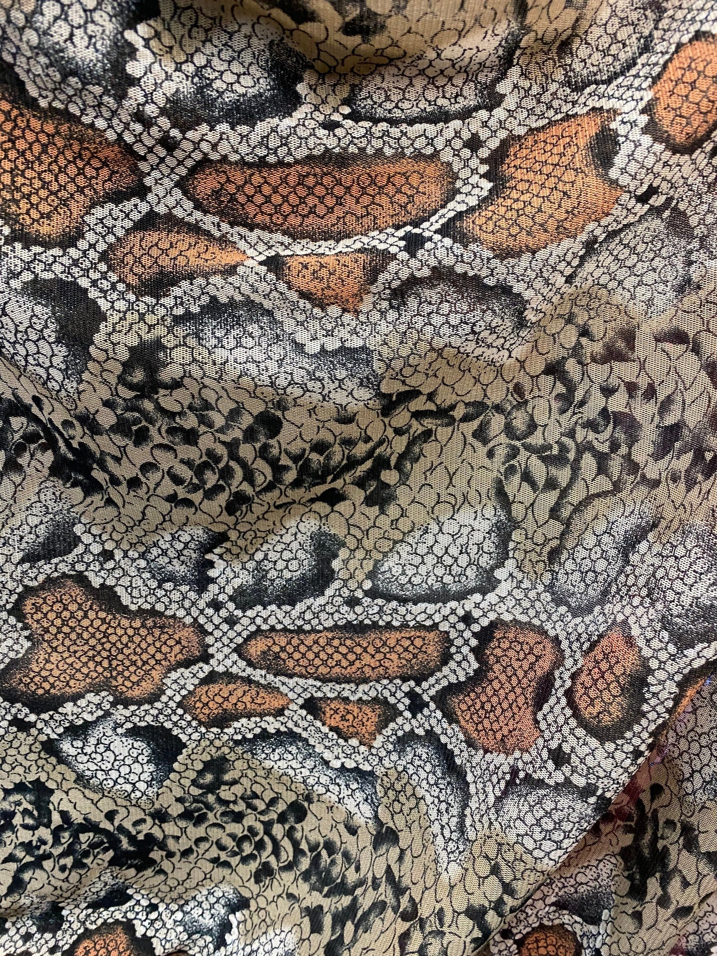 New exotic snake design taupe/black print on stretch mesh 4-way 58/60” Sold by the YD. Ships worldwide from Los Angeles California USA.