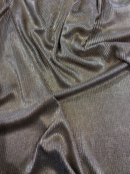 New metallic poly pleated black/gold medium weight fabric 2-way stretch 58/60” Sold by the YD. Ships worldwide from Los Angeles CA USA.