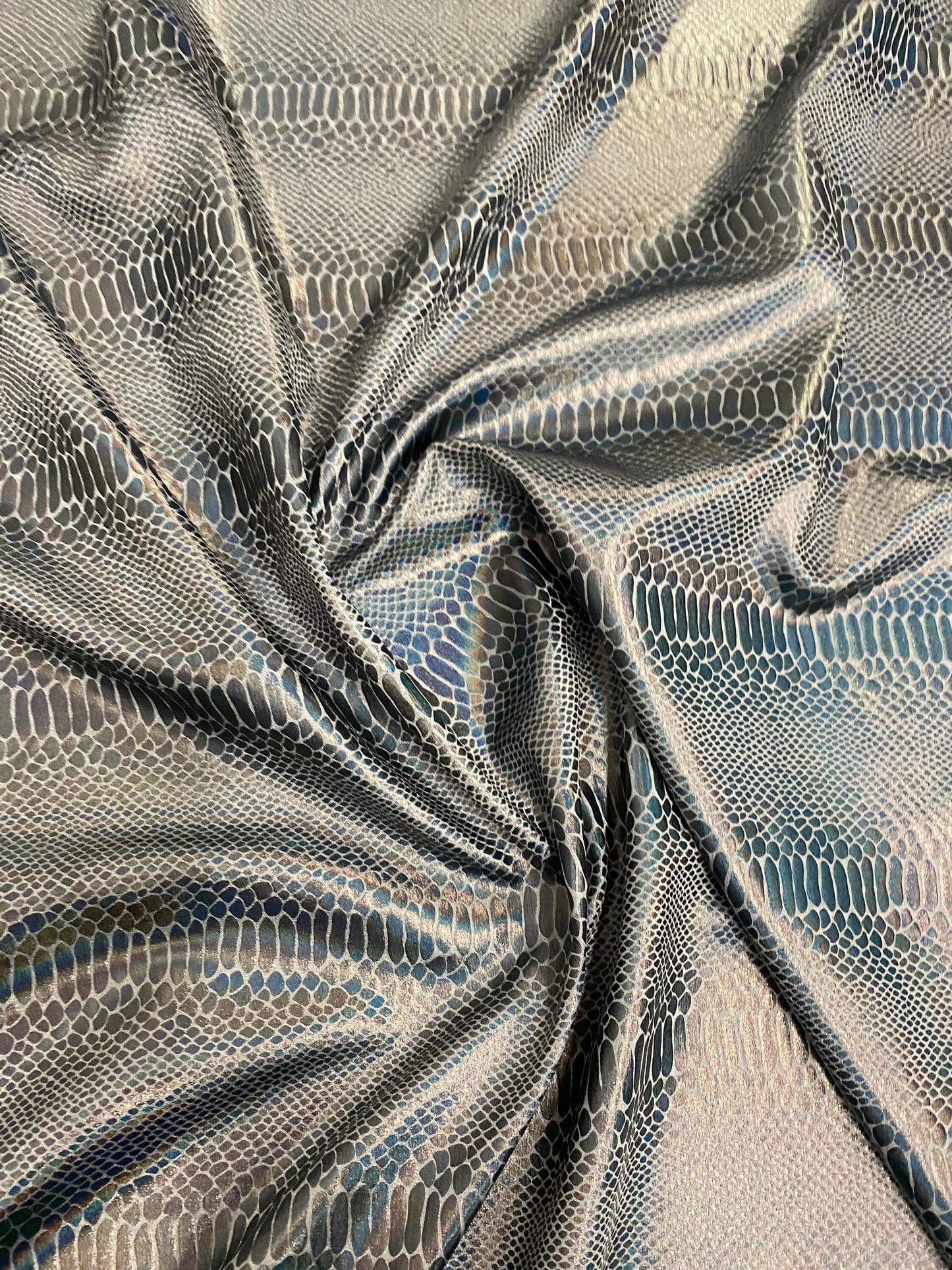 New Iridescent snake design silver/gray metallic hologram nylon spandex 4-way stretch 58/60” Sold by the YD. Ships worldwide from L.A CA.