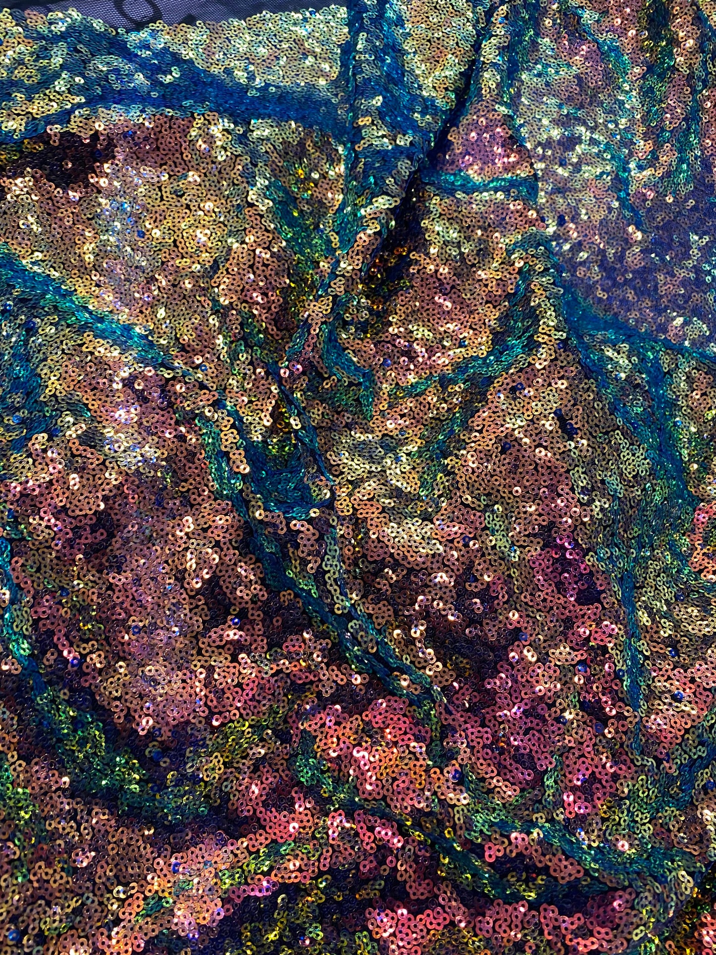 New cosmic iridescent sequins sapphire bronze color on stretch mesh 2-way stretch 58/60” Sold by the YD. Ships worldwide from Los Angeles CA