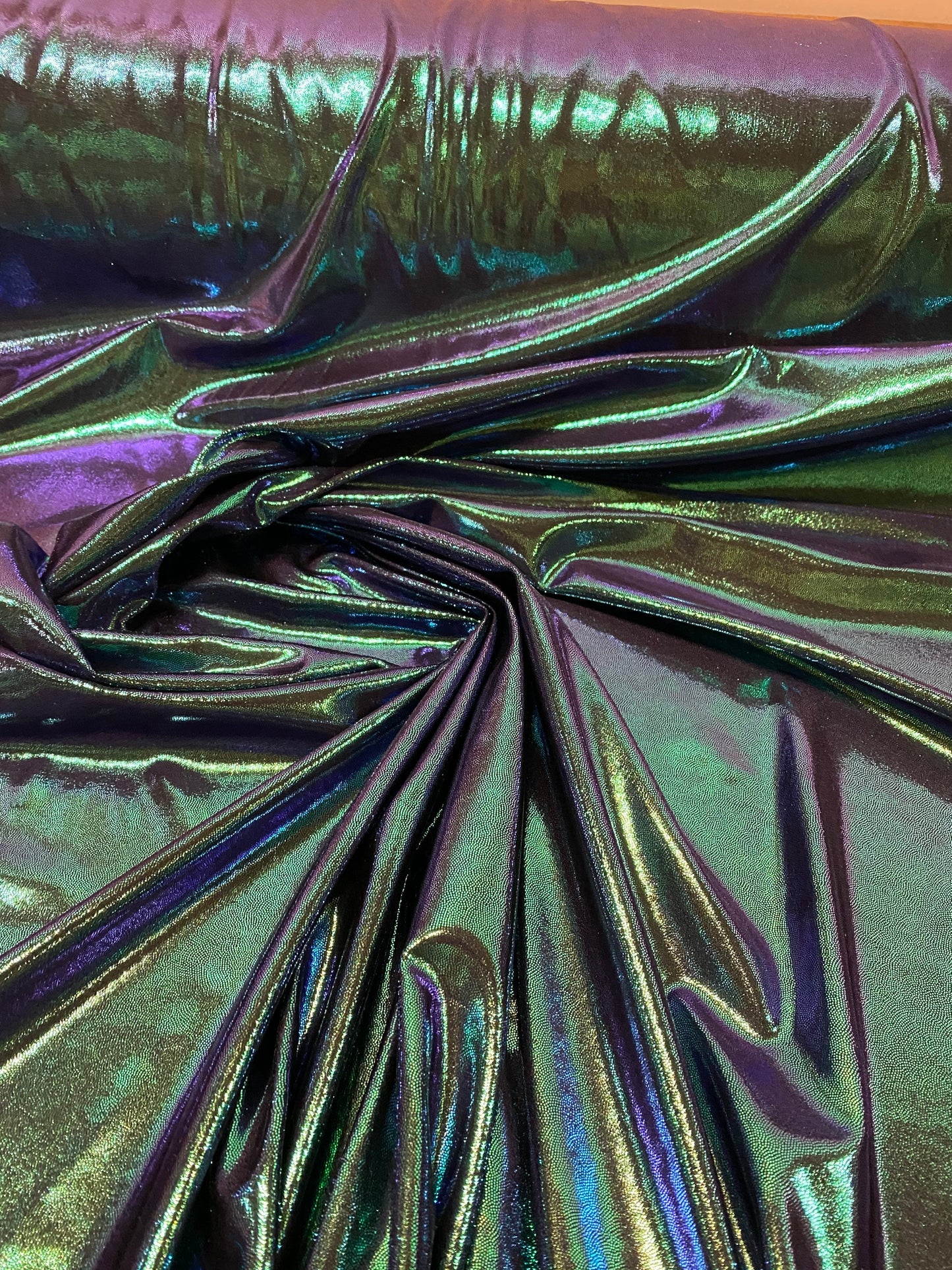 New oil slick iridescent blue green hologram metallic nylon spandex  4-way stretch 58/60” Sold by the YD. Ships worldwide from L.A