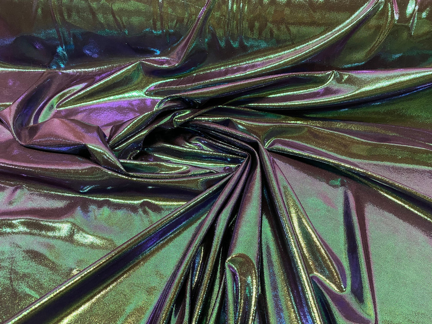 New oil slick iridescent blue green hologram metallic nylon spandex  4-way stretch 58/60” Sold by the YD. Ships worldwide from L.A