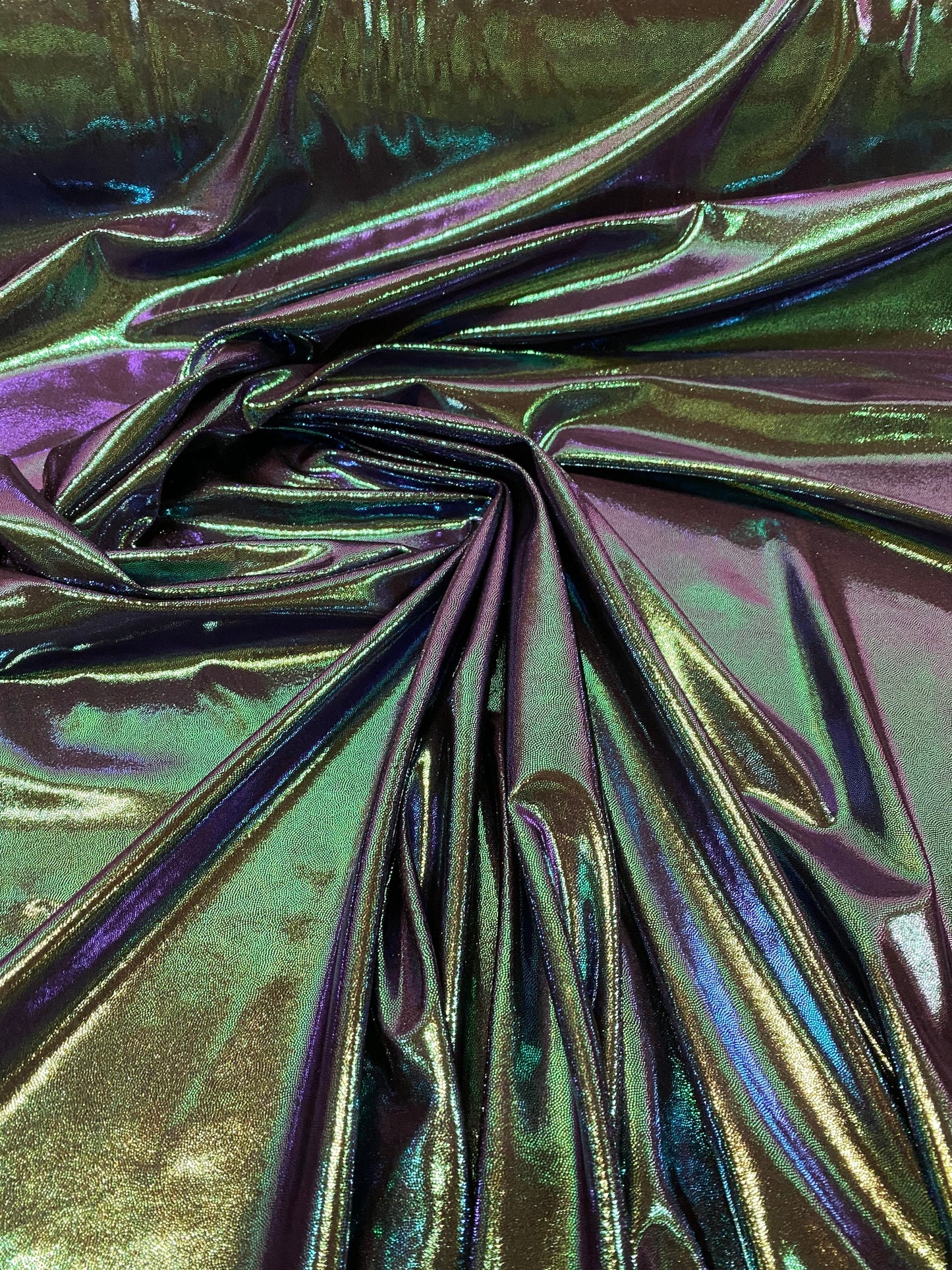 New oil slick iridescent blue green hologram metallic nylon spandex  4-way stretch 58/60” Sold by the YD. Ships worldwide from L.A