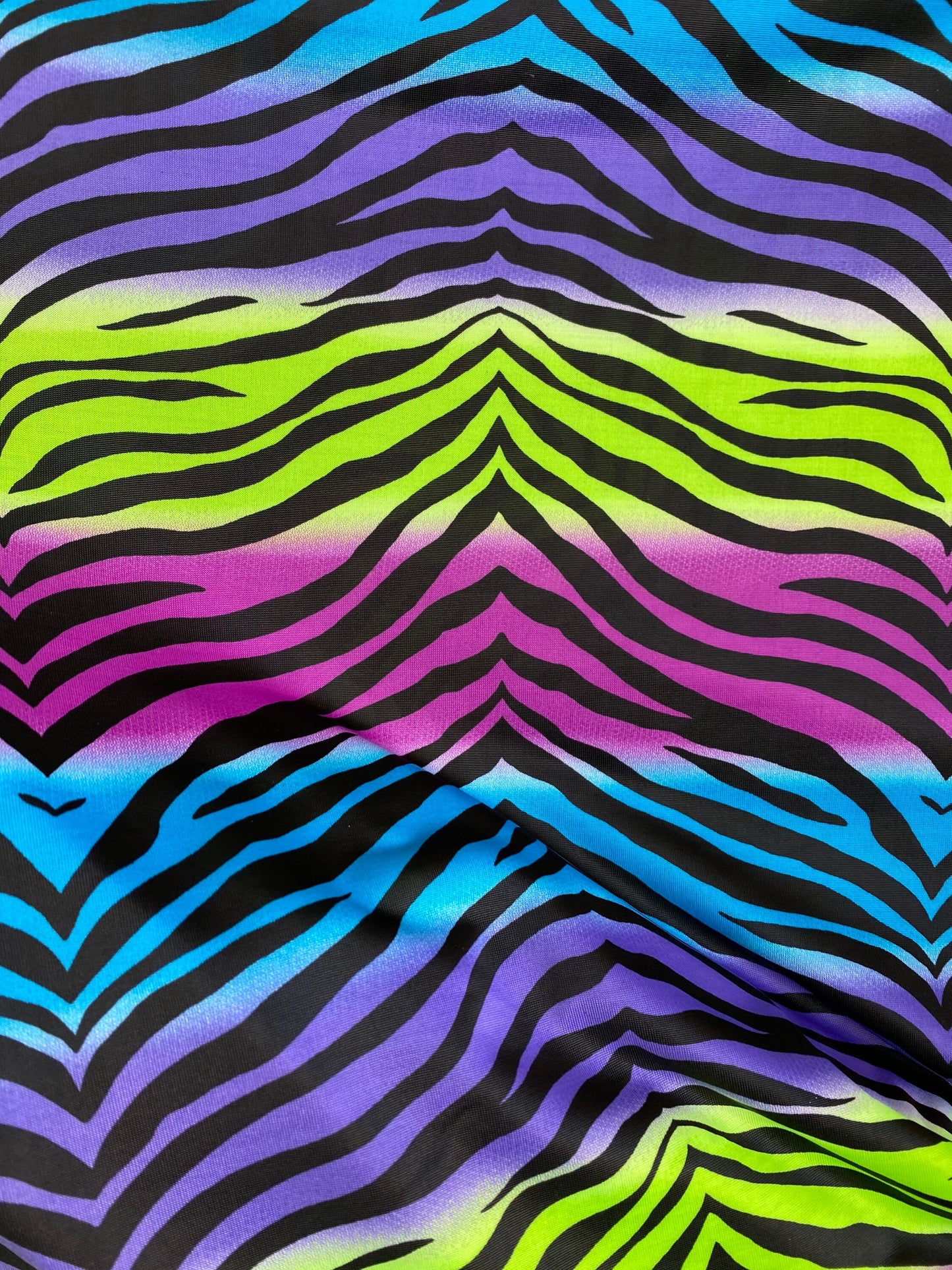 New zebra design rainbow neon green multi poly spandex 4-way stretch medium weight 58/60” Sold by the YD. Ships worldwide from Los Angeles