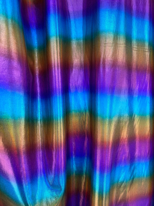 Rainbow all over foil nylon spandex 4-way stretch 58/60” Sold by the YD. Ships worldwide from Los Angeles California USA.