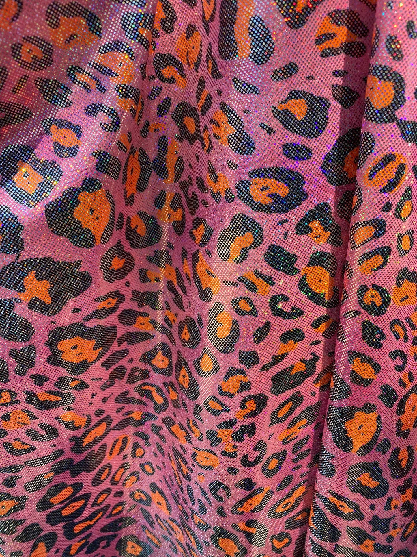 Hologram exotic leopard design metallic nylon spandex 4-way stretch 58/60” Sold by the YD. Ships worldwide from Los Angeles California USA.
