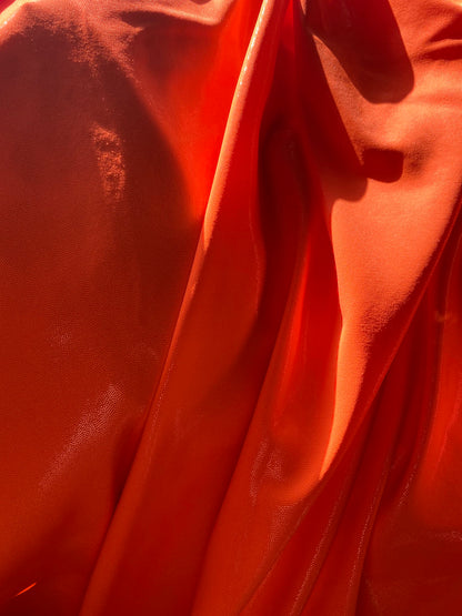 Neon Orange foggy foil nylon spandex 4-way stretch 58/60” Sold by the YD. Ships worldwide from Los Angeles California USA.