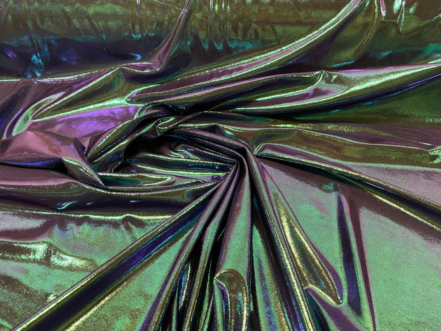 New oil slick iridescent blue green hologram metallic nylon spandex  4-way stretch 58/60” Sold by the YD. Ships worldwide from L.A