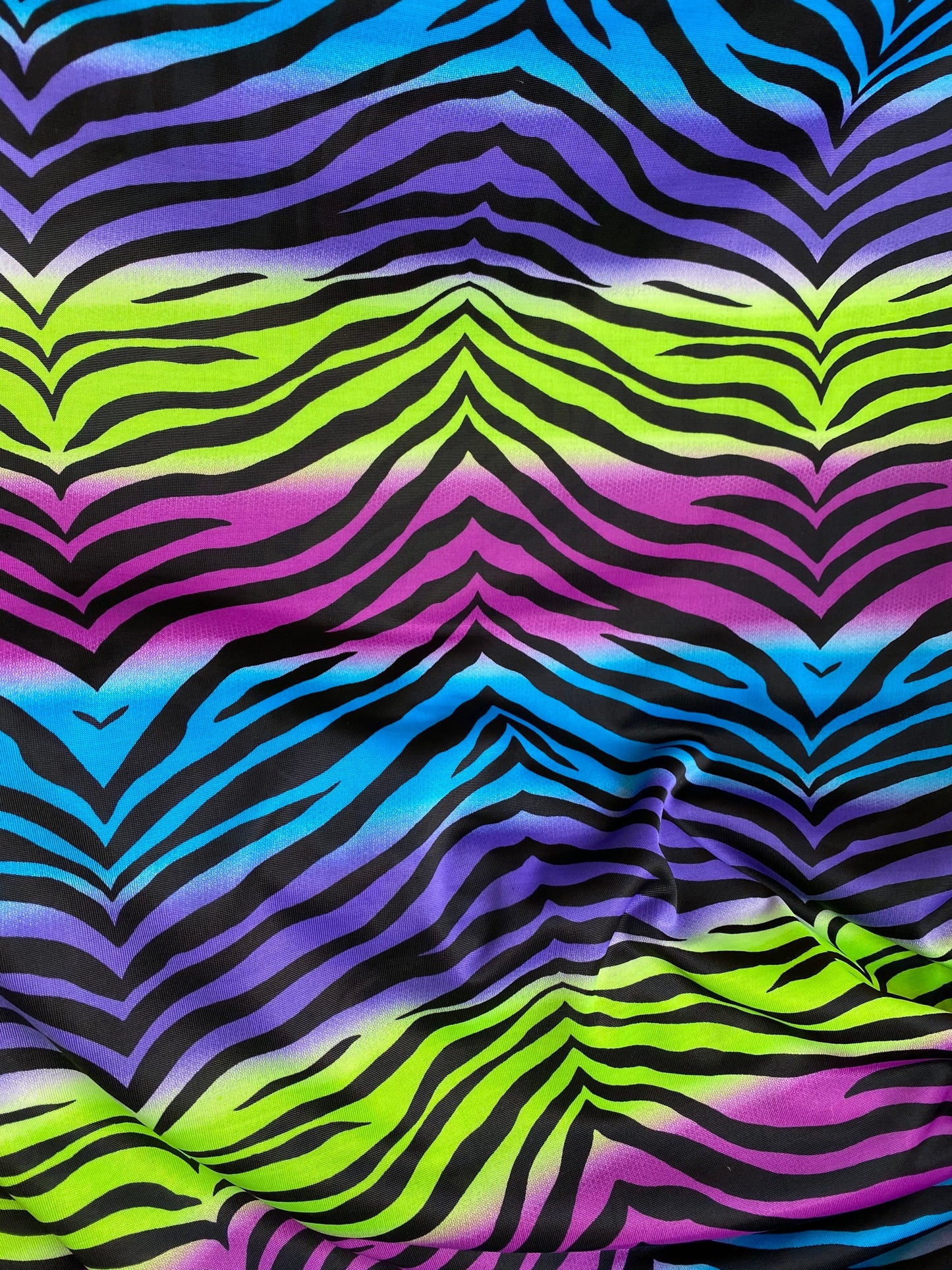 New zebra design rainbow neon green multi poly spandex 4-way stretch medium weight 58/60” Sold by the YD. Ships worldwide from Los Angeles