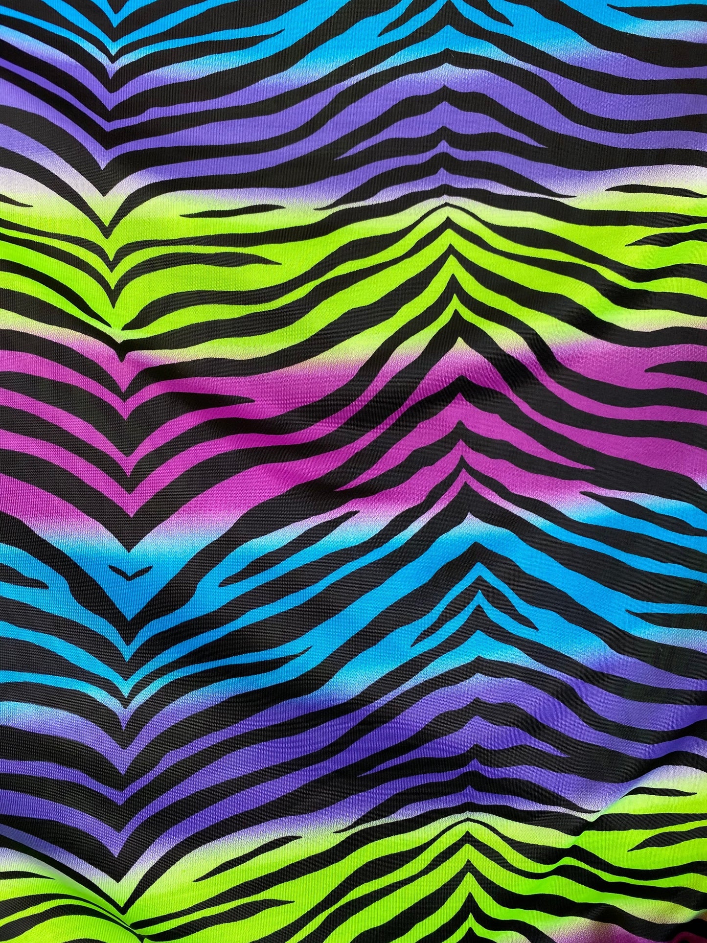 New zebra design rainbow neon green multi poly spandex 4-way stretch medium weight 58/60” Sold by the YD. Ships worldwide from Los Angeles