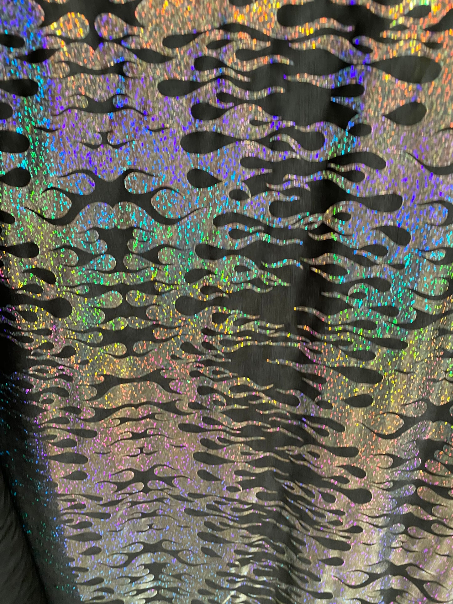 New hologram flames design metallic poly spandex black/silver 2-way stretch 58/60” Sold by the YD. Ships worldwide from Los Angeles CA USA.