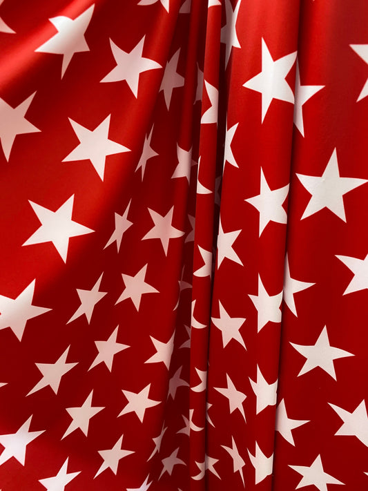 New stars design red/white print on nylon spandex 4-way Stretch 58/60” Sold by the YD. Ships worldwide from Los Angeles California USA.
