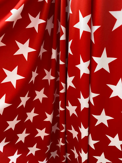 New stars design red/white print on nylon spandex 4-way Stretch 58/60” Sold by the YD. Ships worldwide from Los Angeles California USA.