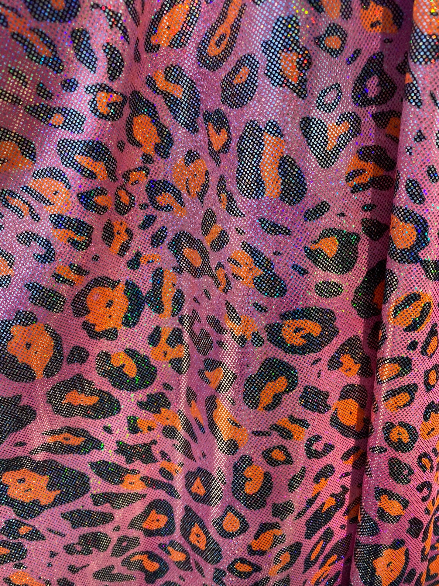 Hologram exotic leopard design metallic nylon spandex 4-way stretch 58/60” Sold by the YD. Ships worldwide from Los Angeles California USA.