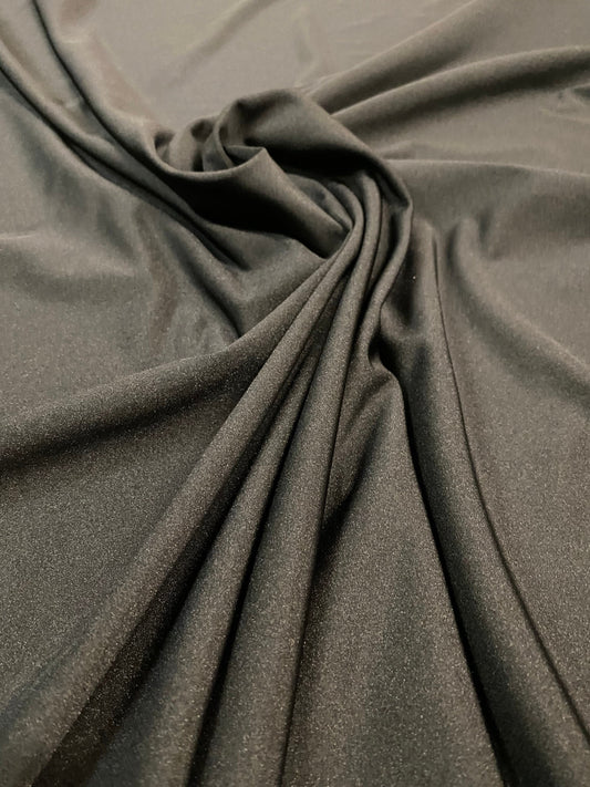 Great quality shiny black nylon spandex 4-way stretch 58/60” Sold by the YD. Ships worldwide from Los Ángeles California USA.