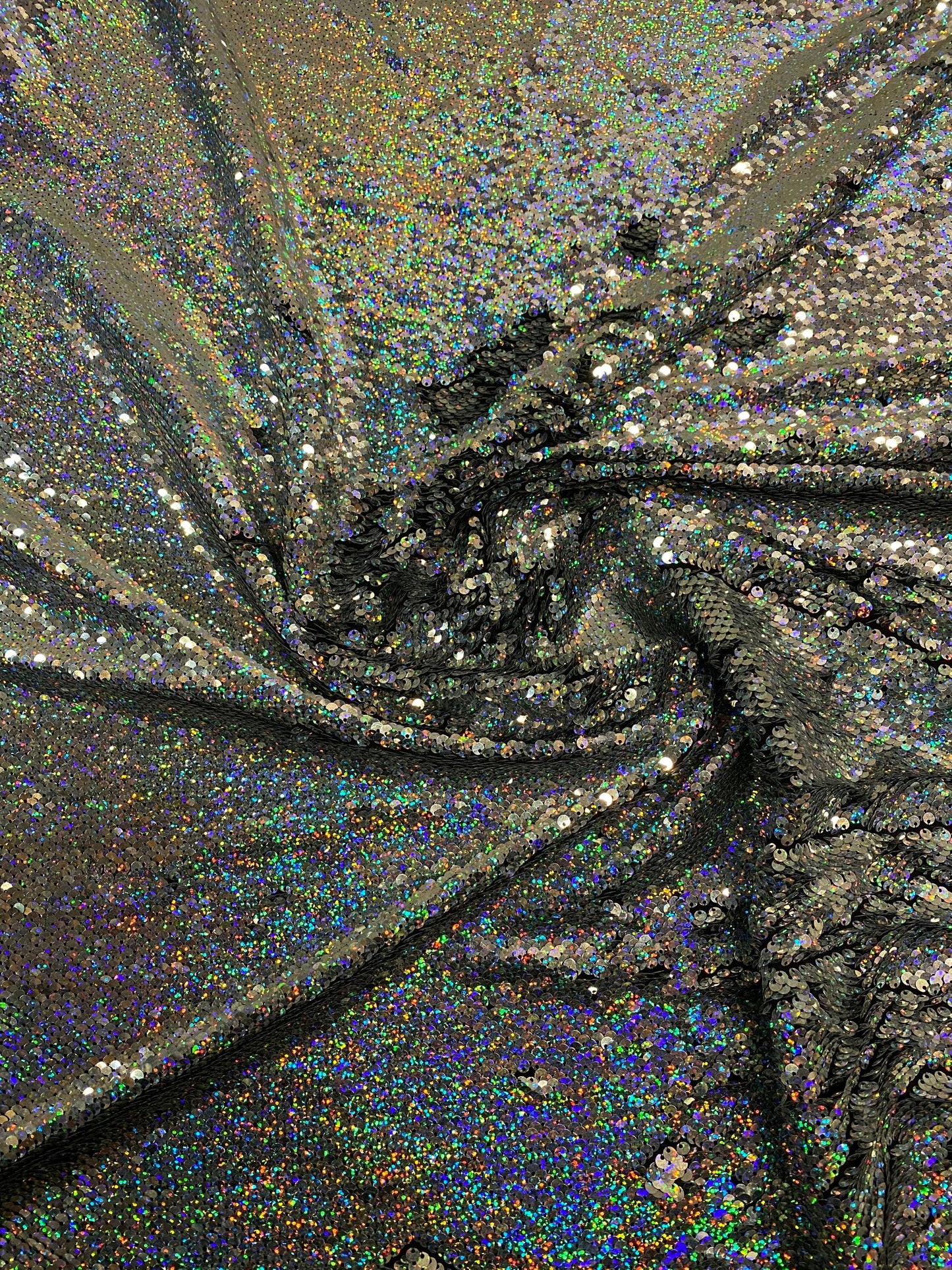 New hologram silver/silver reversible flip up sequins on spandex base 2-way stretch 58/60” Sold by the YD. Ships worldwide from Los Angeles