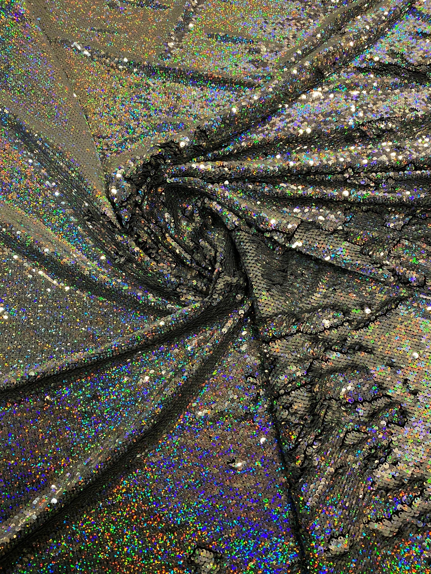 New hologram silver/silver reversible flip up sequins on spandex base 2-way stretch 58/60” Sold by the YD. Ships worldwide from Los Angeles