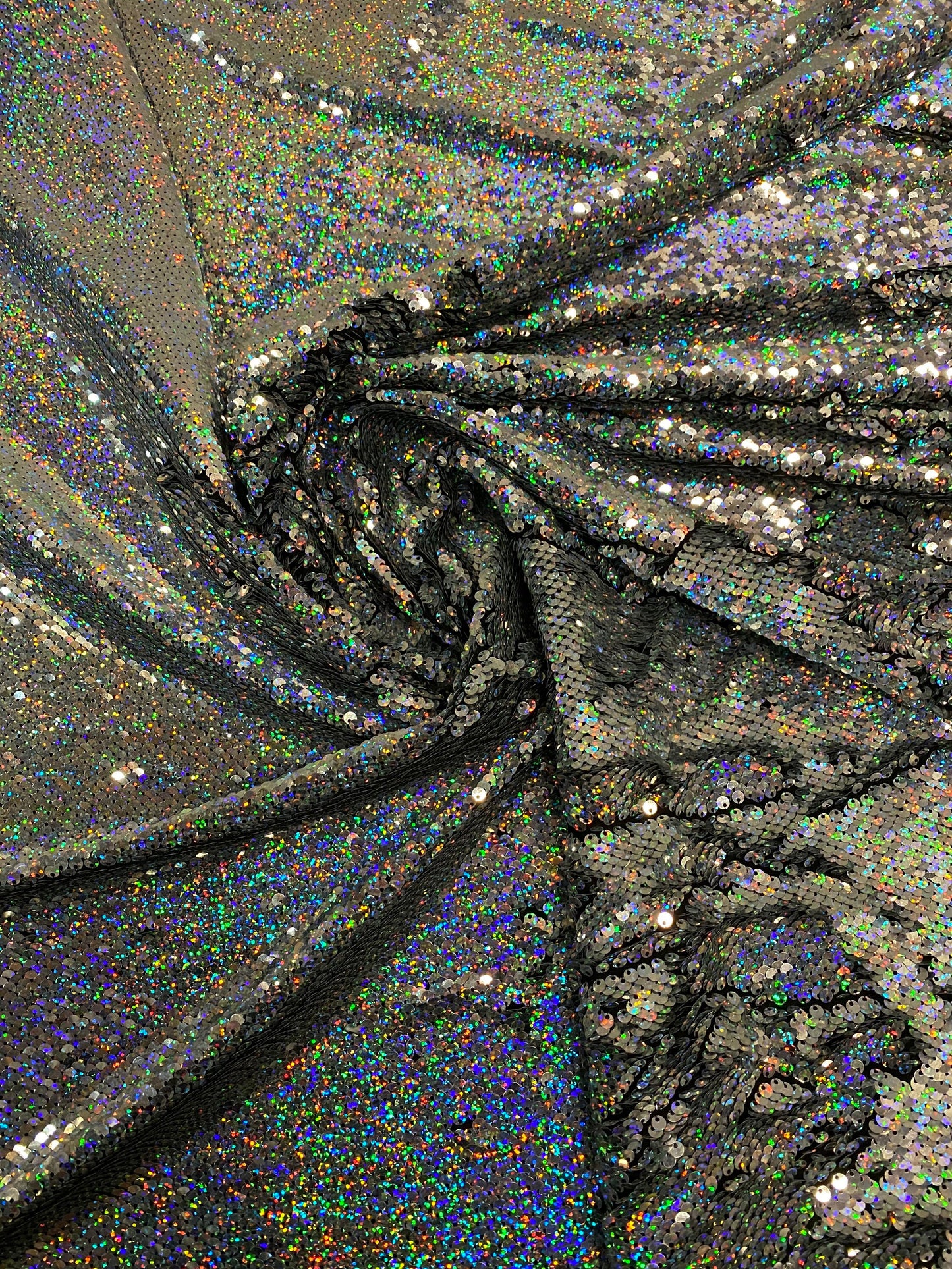 New hologram silver/silver reversible flip up sequins on spandex base 2-way stretch 58/60” Sold by the YD. Ships worldwide from Los Angeles