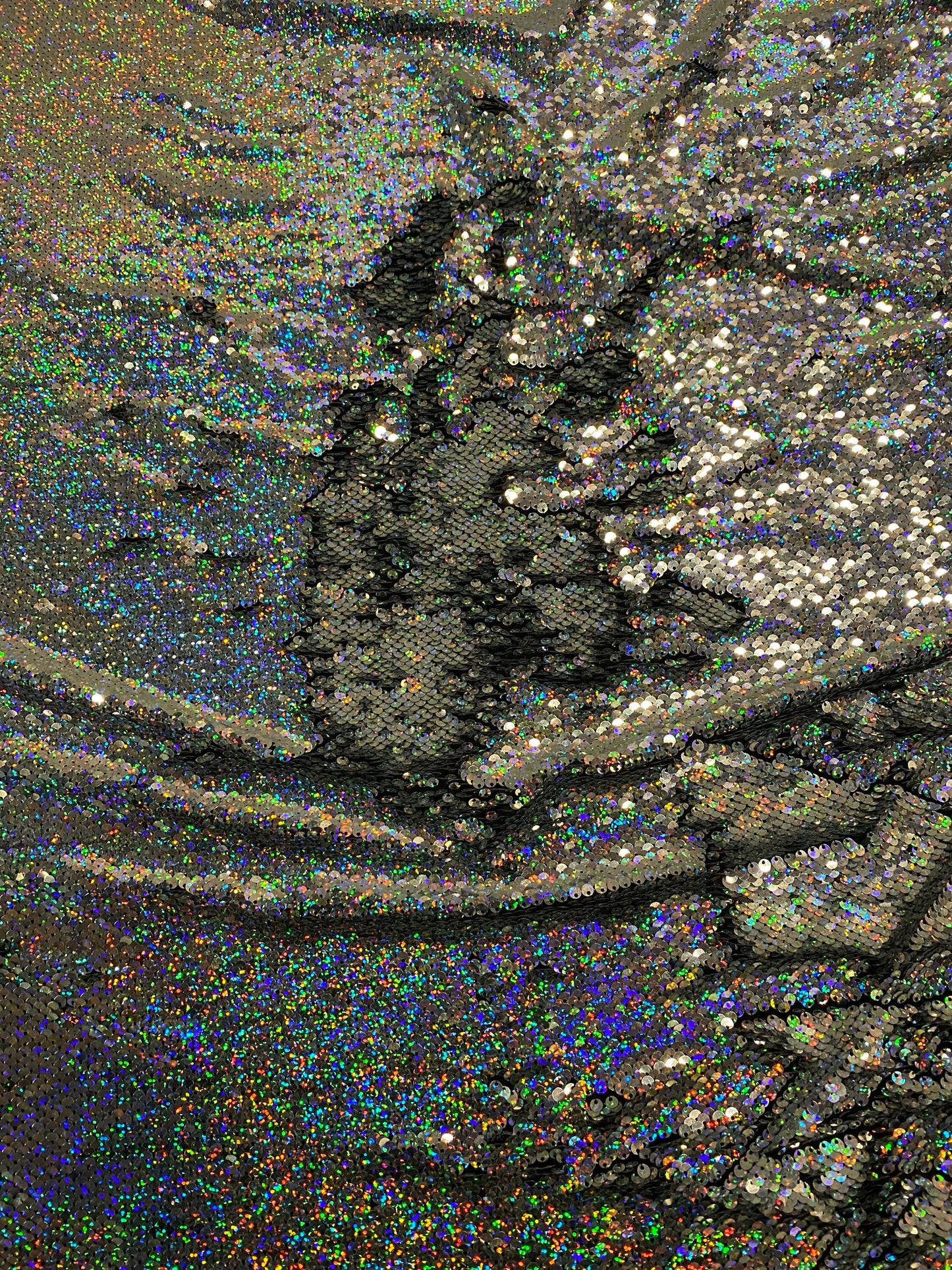 New hologram silver/silver reversible flip up sequins on spandex base 2-way stretch 58/60” Sold by the YD. Ships worldwide from Los Angeles