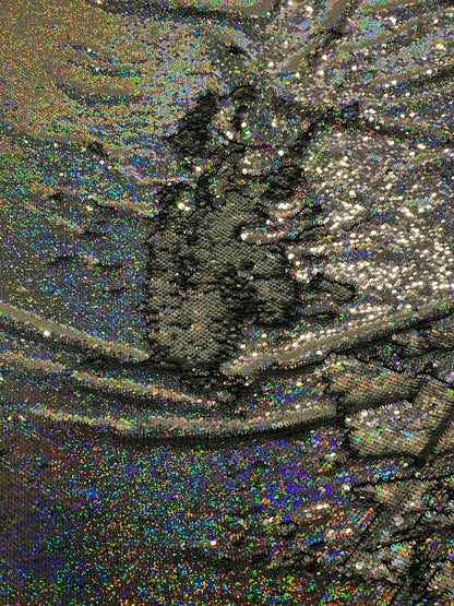 New hologram silver/silver reversible flip up sequins on spandex base 2-way stretch 58/60” Sold by the YD. Ships worldwide from Los Angeles