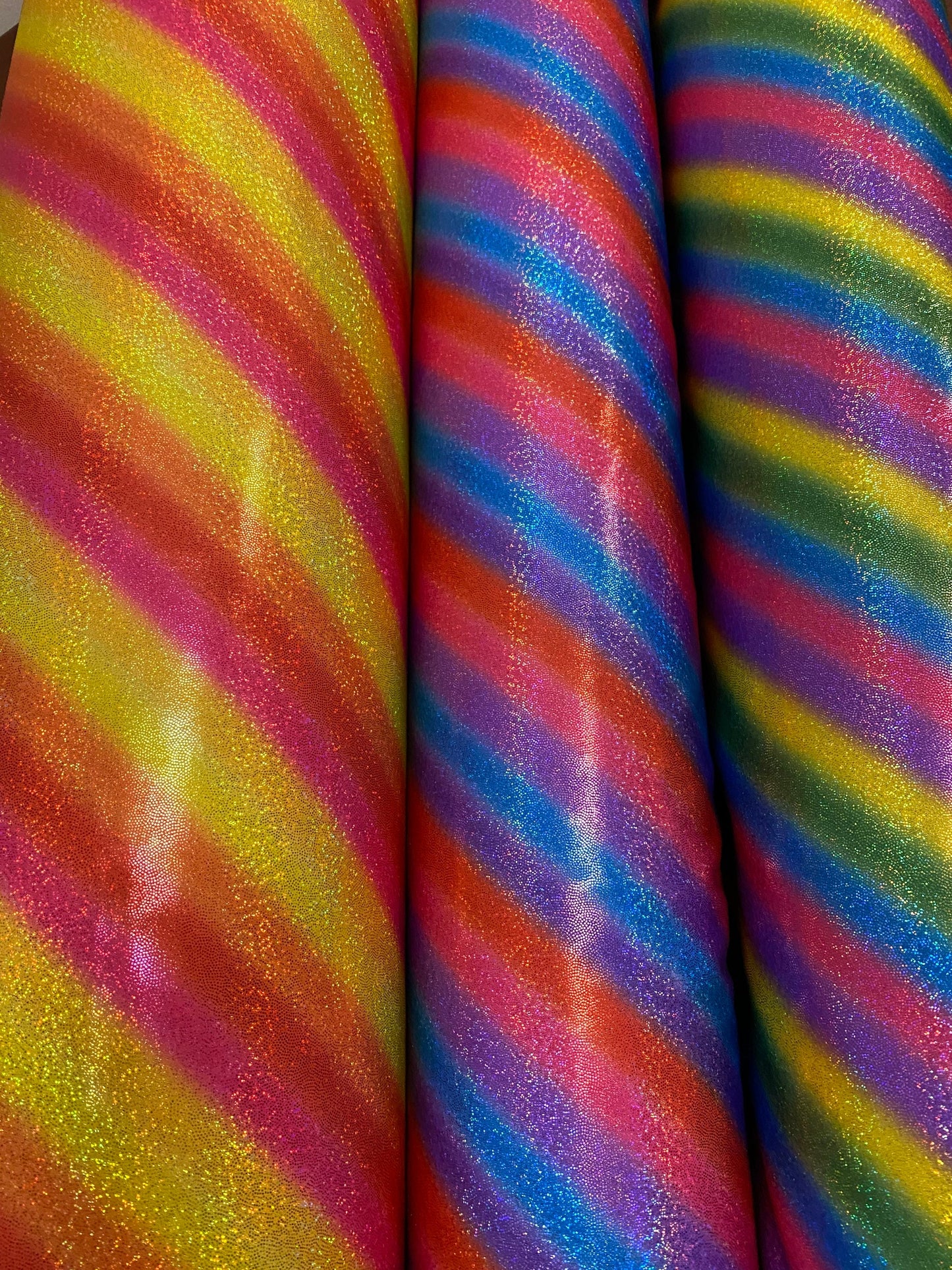 New Luxury rainbow with foggy hologram foil metallic nylon spandex 4-way stretch 58/60” Sold by the YD. Ships worldwide from L.A