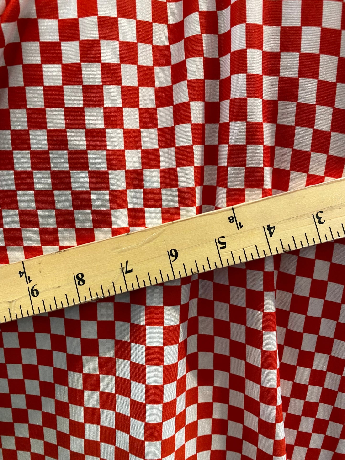 New small Chequers design red/white print on poly spandex 4-way stretch 58/60” Sold by the YD. Ships worldwide from Los Angeles California