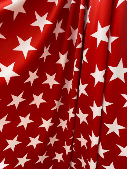New stars design red/white print on nylon spandex 4-way Stretch 58/60” Sold by the YD. Ships worldwide from Los Angeles California USA.