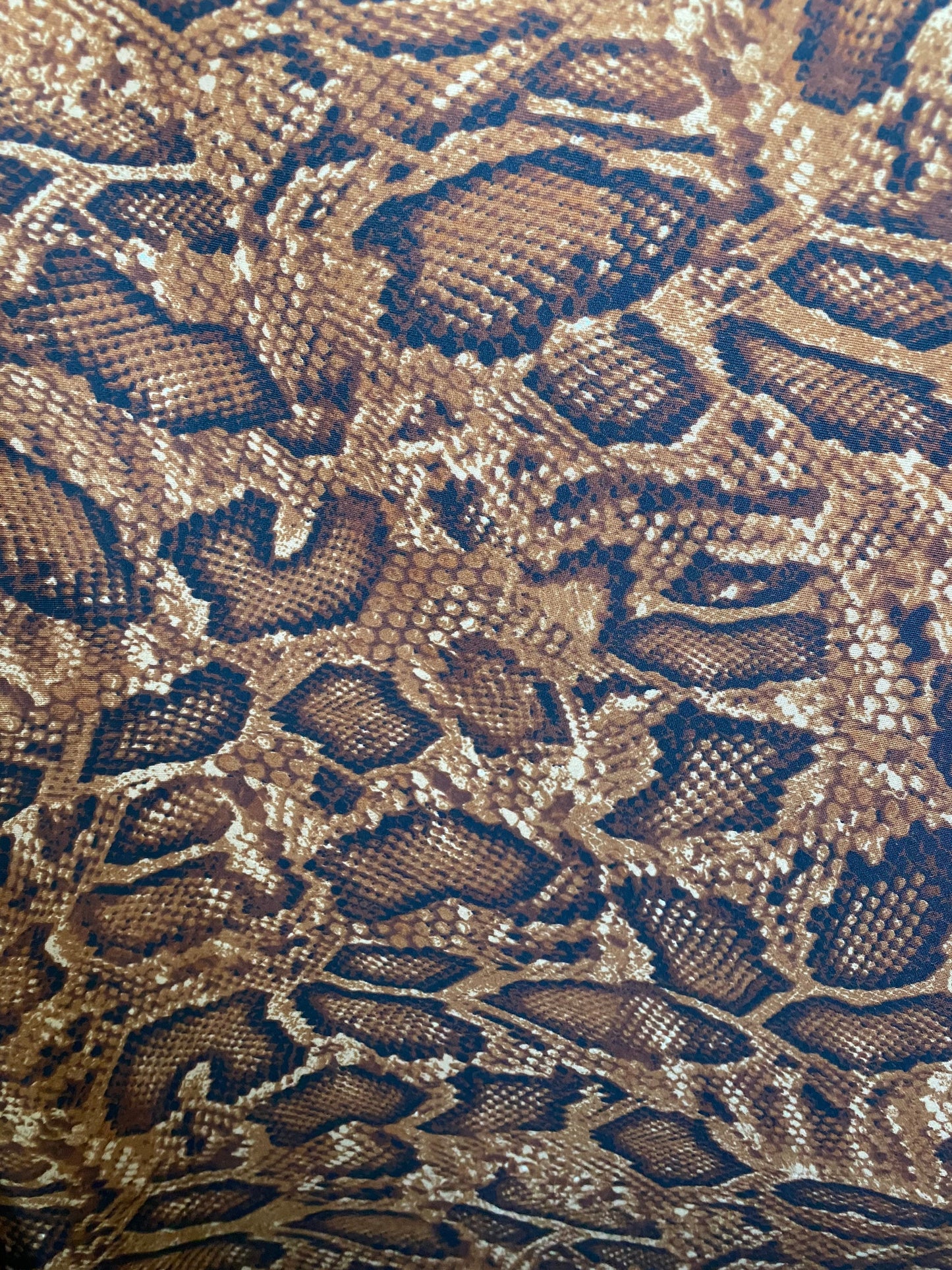 New exotic snake design copper print on poly techno 2-way stretch medium weight 58/60” Sold by the YD. Ships worldwide