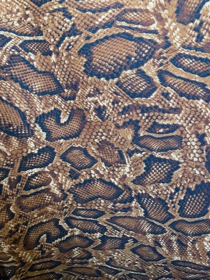 New exotic snake design copper print on poly techno 2-way stretch medium weight 58/60” Sold by the YD. Ships worldwide